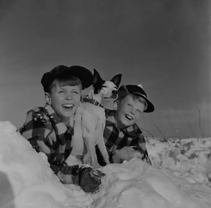 Twin boys with pet dog