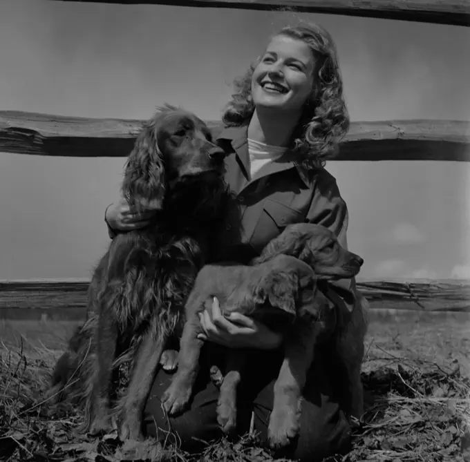 Young woman with cocker spaniels