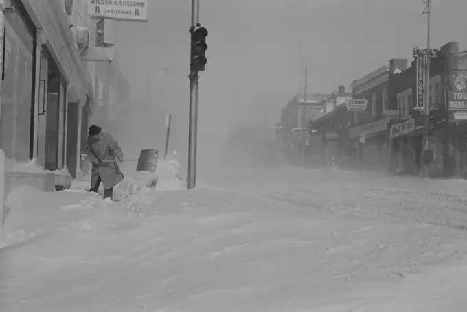 USA, Pennsylvania, Man digging snow from street