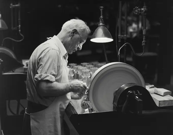 Vintage Photograph. Man polishing glass at wheel. Frame 2