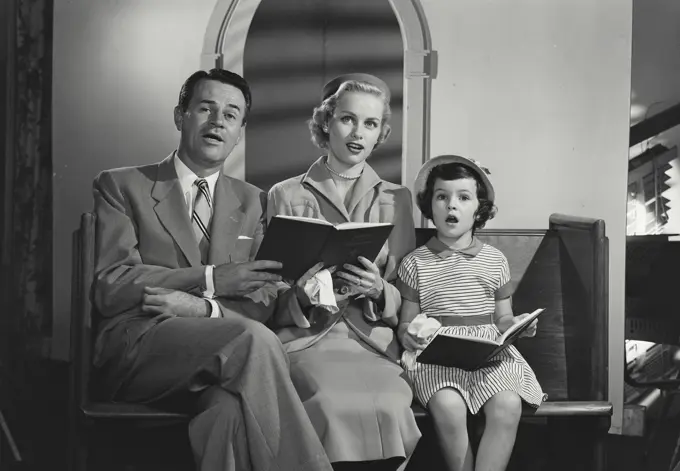 Vintage Photograph. Family singing songs together at church