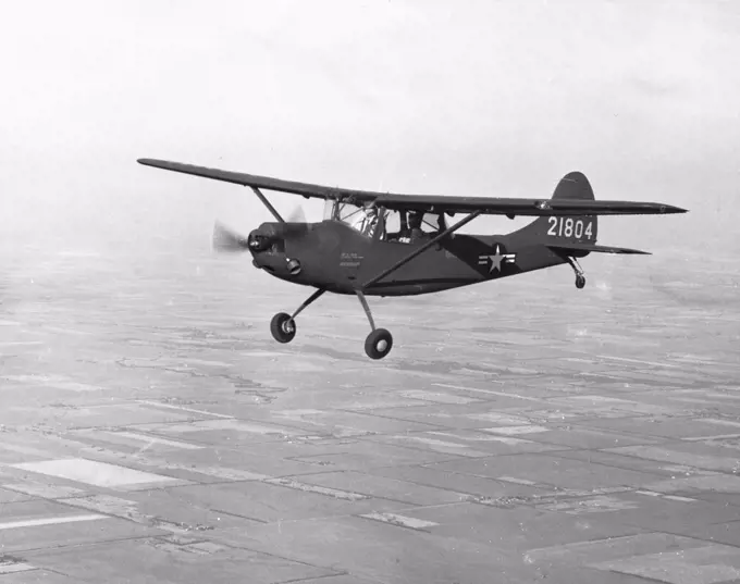 Side profile of a military airplane in flight, XL-19B