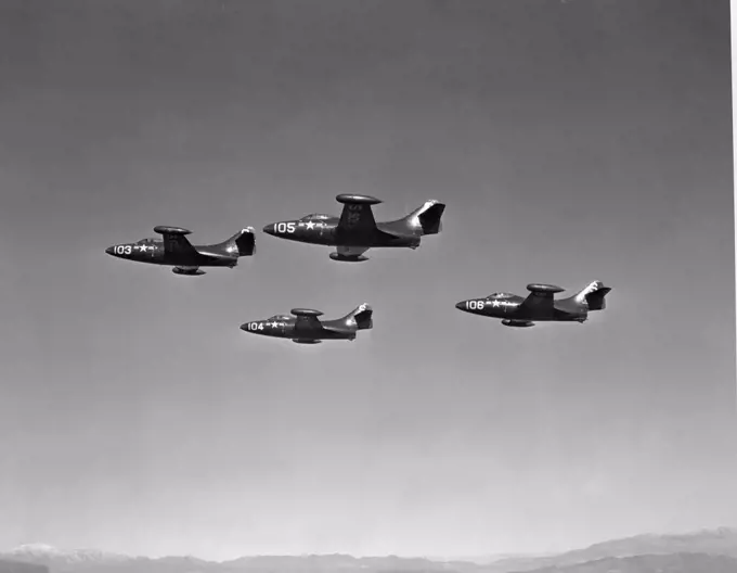 Low angle view of four fighter planes flying in formation, F9F Panther