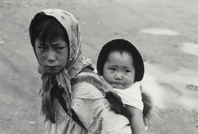 Vintage Photograph. Eskimo Girl with little sister on back.