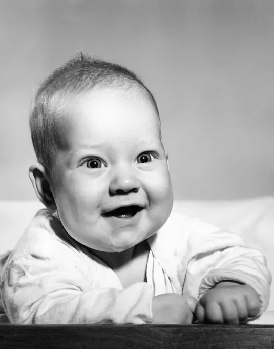 Studio portrait of baby boy laughing