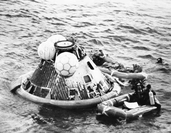 High angle view of a rescue squad near a space capsule in the sea