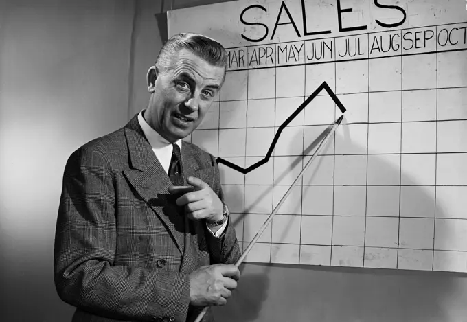 Business man giving presentation in front of chart