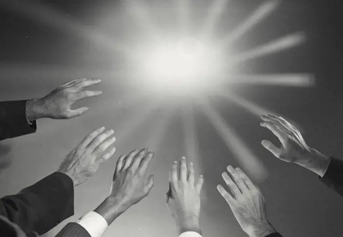 Vintage photograph. Close-up of people's hands raised