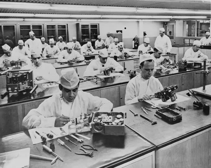 Group of male workers working in an aircraft assembly plant of factory, California, USA