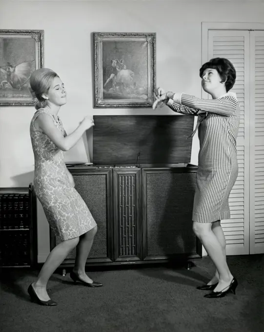 Side profile of two teenage girls dancing