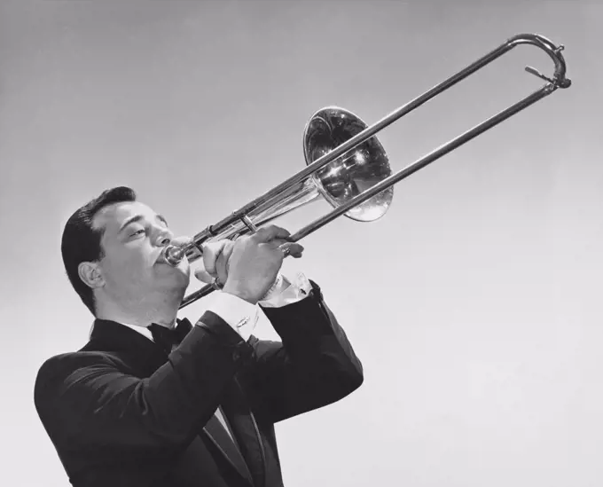 Mid adult man playing a trombone