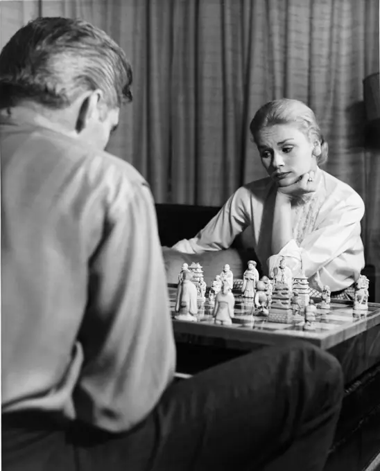 Couple playing chess at home