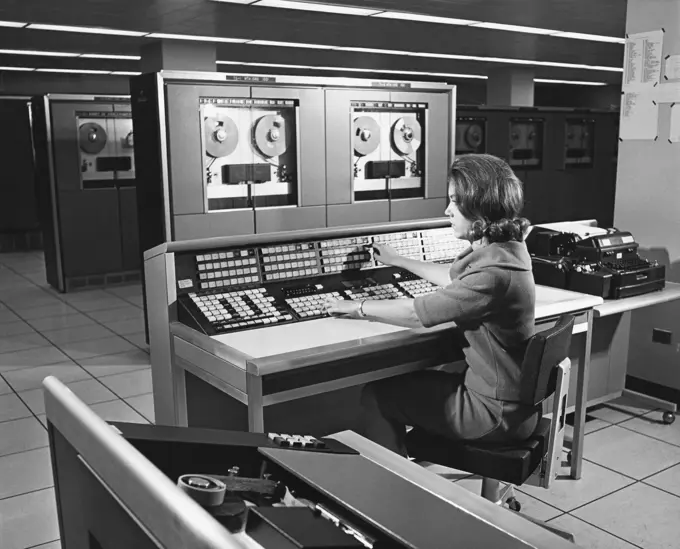 Businesswoman working on a mainframe computer in an office