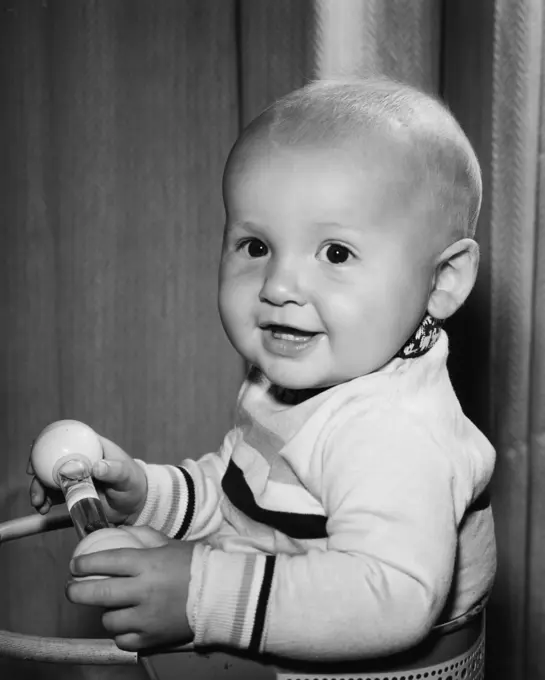 Portrait of smiling baby holding toy