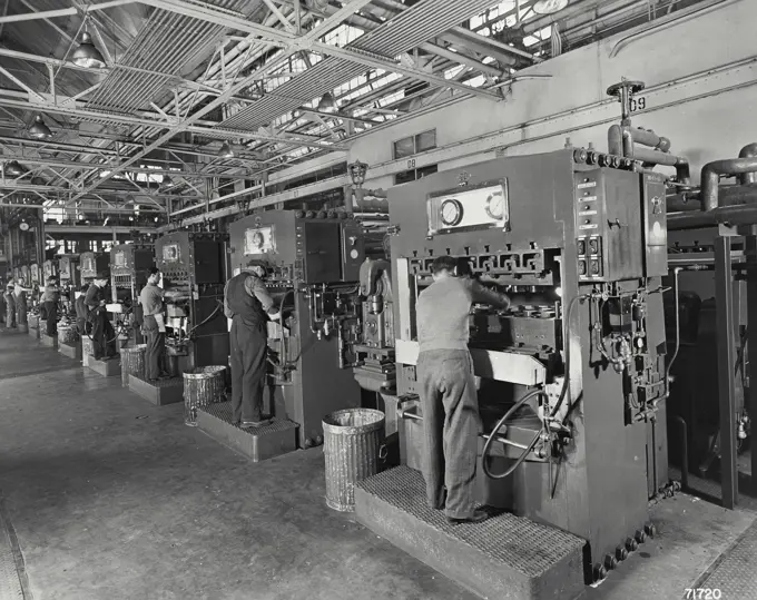 Vintage Photograph. Plastic injection molding presses. The plastic used here is obtained from the soybean.