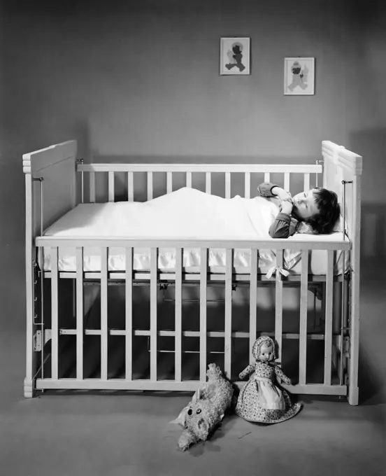 Boy sleeping in crib