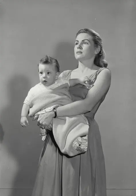 Vintage Photograph. Mother cradling son swaddled in baby blanket