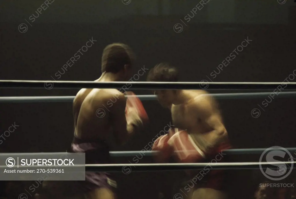 Two young men boxing in a boxing ring