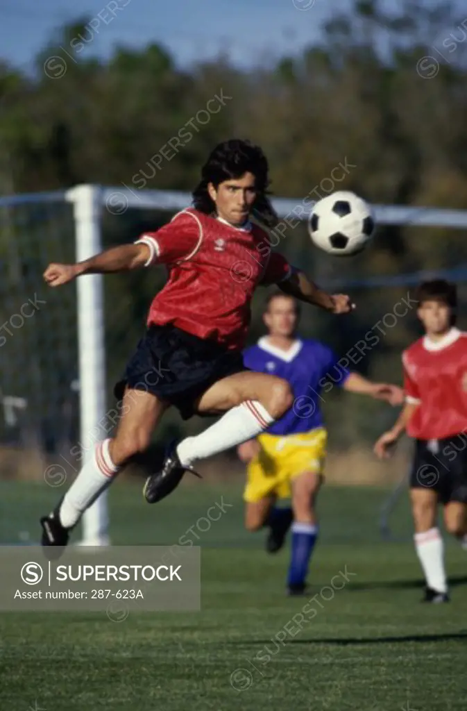 Soccer player hitting a soccer ball