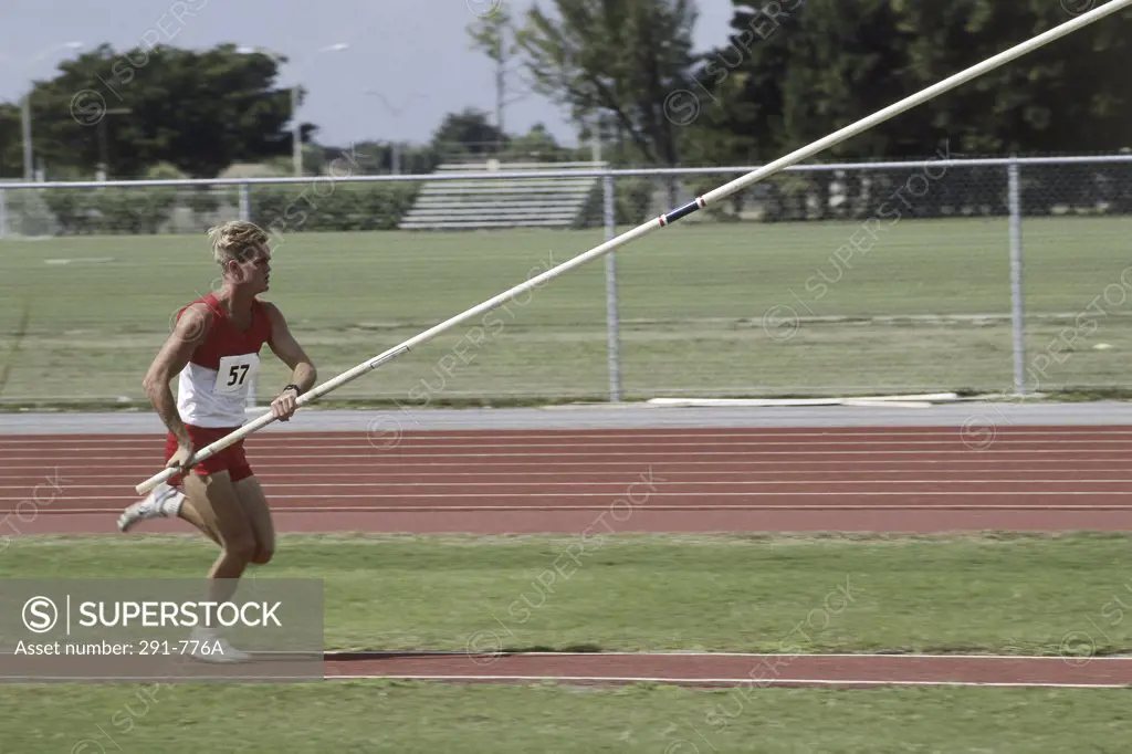 Male athlete pole vaulting