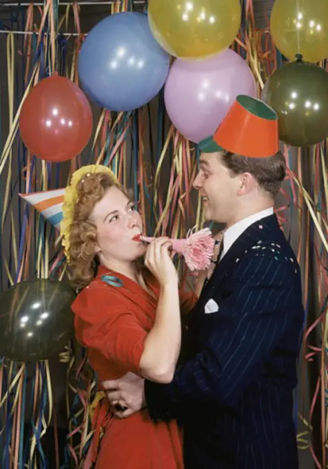 Mid adult couple dancing at New Year's party