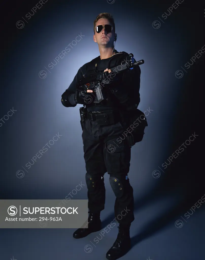 Police officer holding a machine gun