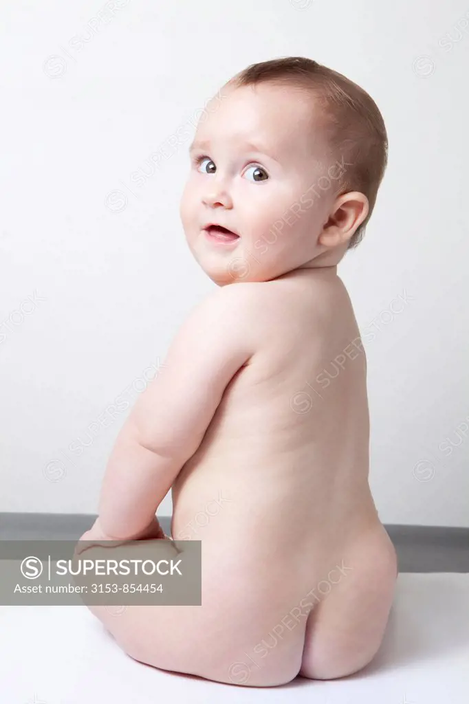 naked baby girl sitting