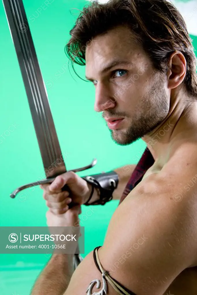 Young man in warrior costume holding a sword