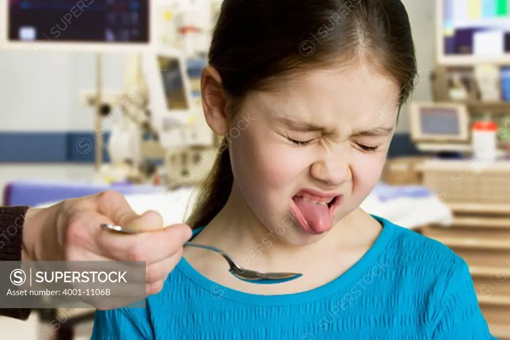 Girl taking medicine at the doctor's office