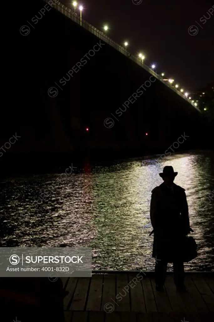 Silhouette of a spy standing at the riverside, Washington DC, USA