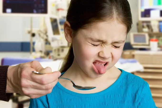 Girl taking medicine at the doctor's office