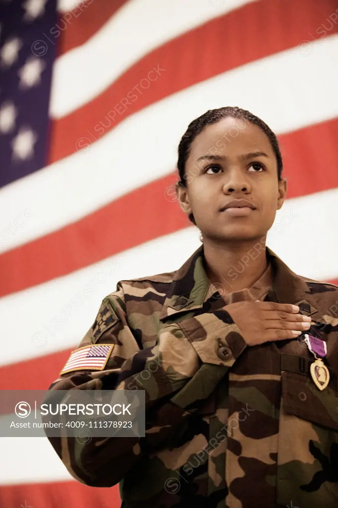 Hispanic female soldier in front of American flag