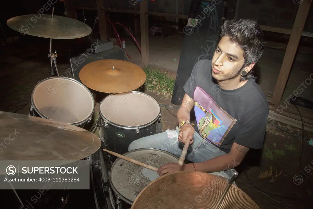 Hispanic man playing the drums