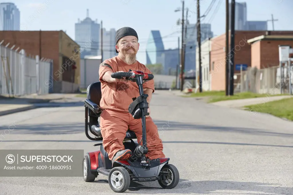 Portrait of male dwarf in the street in Texas looking into camera with tough attitude. 