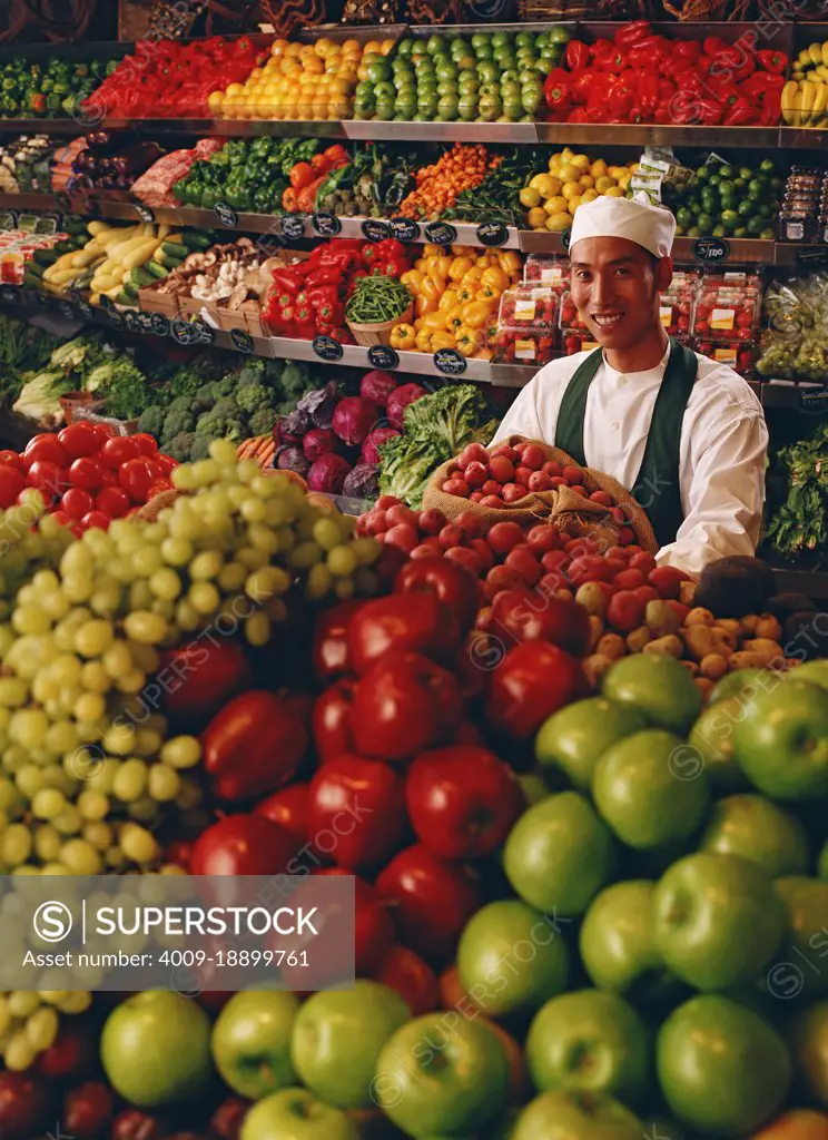 Associate in produce department stocking and ensuing freshness of produce 