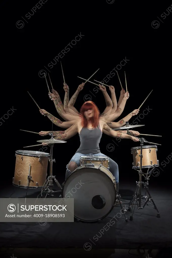 Stroboscopic photos of red headed female drummer 