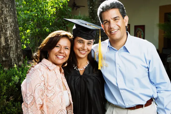 Graduate and parents smiling for the camera