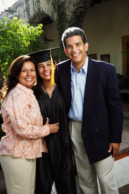 Graduate and parents smiling for the camera