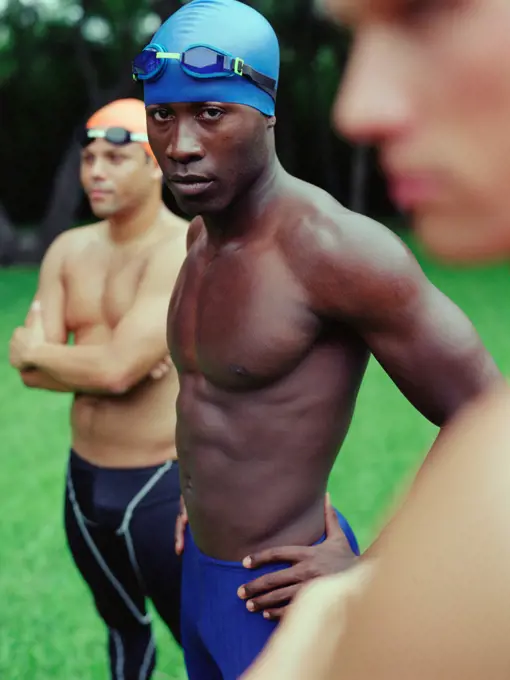 Multi-ethnic male swimmers outdoors