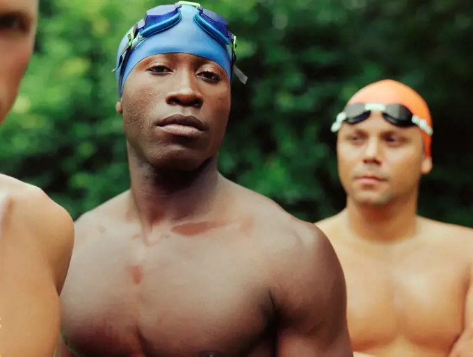 Multi-ethnic male swimmers outdoors