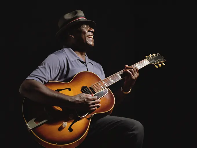 African American man playing guitar