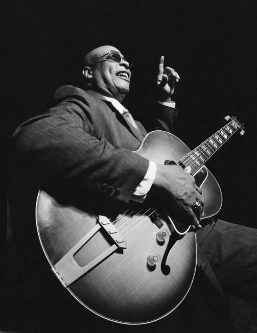 African American man playing guitar