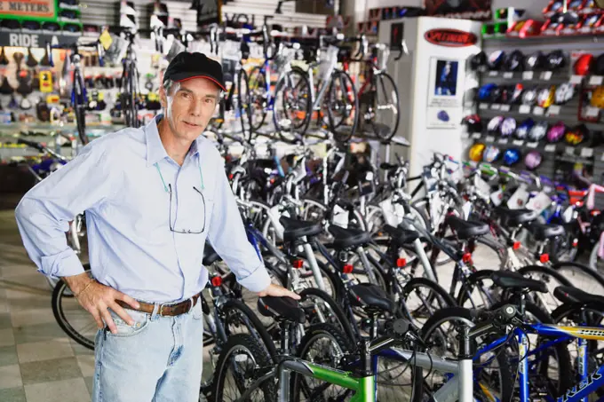 Portrait of man standing in bike shop