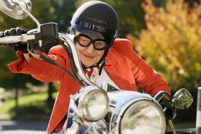 Elderly woman driving a motorcycle