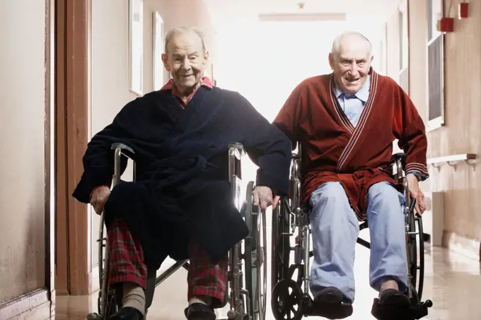 Elderly men racing in wheelchairs