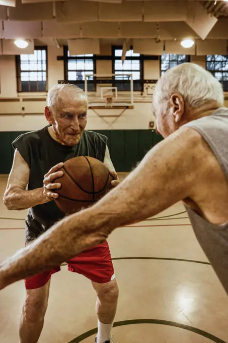 Elderly men playing basketball