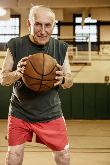 Elderly man playing basketball