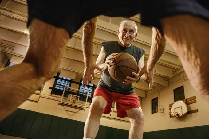 Elderly men playing basketball