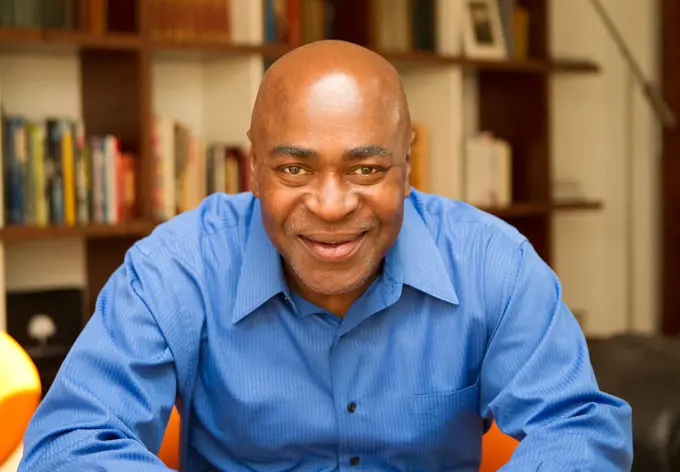 Smiling Black man in living room