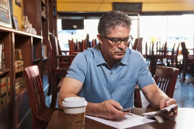 Business owner going paperwork in cafe